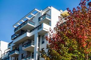 Sunny autumn in the city, house with balcony photo