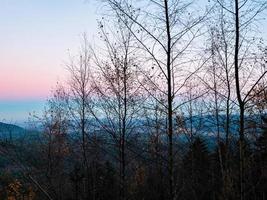 White snow and blue sky. Panoramic view of the silhouettes of the mountains. photo