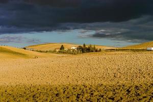 Villa in Italy, old farmhouse in the waves of tuscanian fields and hills photo