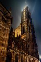 Stunning bottom view of Strasbourg Cathedral illuminated at night, Europe's tallest building. photo