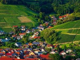 Little cozy german village between the green hills, vineyards in Black Forest photo