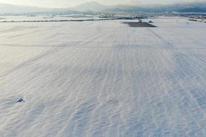 Snow-covered white fields in Alsace, top view. White desert. photo