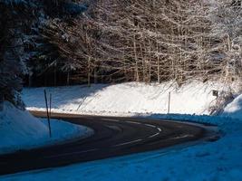 Road in the winter snowy forest. Mountains of the Vosges. photo