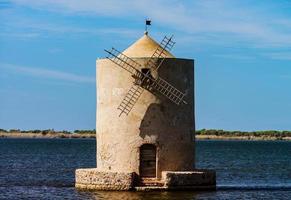 Old windmill in italy, tuscany. Standing in the water photo