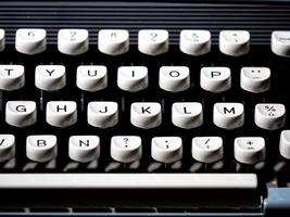 Vintage typewriter, writer or author's tool, inspiration and creativity. On a black background. photo