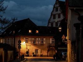 Glowing warm homely windows in a small Alsatian village. Comfort and warmth at home on a winter evening. photo