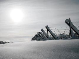 Alsace vineyards under heavy snow on a sunny winter day. Details and top view. photo