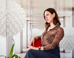 Beautiful young woman posing in a chair. Everyday clothes. Real emotions. photo