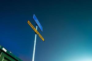 Minimalistic composition. Road sign on night sky background photo