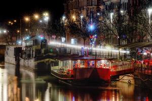Night restaurants on big boats, river Ill in Strasbourg photo