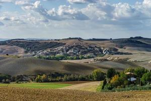 Villa in Italy, old farmhouse in the waves of tuscanian fields and hills photo