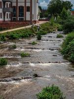 Powerful waterfall on the Kinzig river. Full-flowing river after the rains. photo