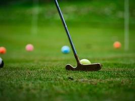 Multi-colored golf balls on green grass. Golf Club. Sports and recreation. photo