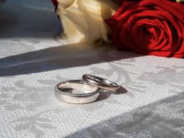 Precious wedding rings and bridal bouquet. Wedding advertising photography. photo