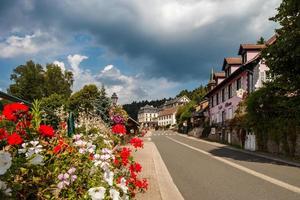 Flowering village in Alsace. Sunlit streets full of flowers. photo