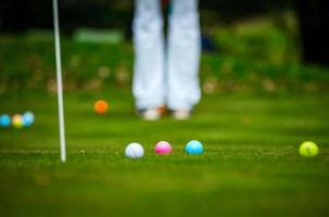 Multi-colored golf balls on green grass. Golf Club. Sports and recreation. photo