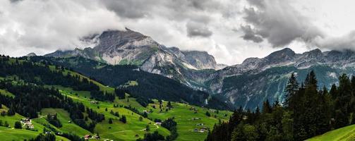 Terrible lifeless rocks, a glacier in the Alps, clouds and fog spread over the peaks of the mountains photo