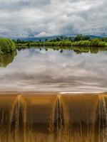 Powerful waterfall on the Kinzig river. Full-flowing river after the rains. photo