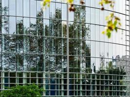 The modern building from glass and steel. Reflections in a glass facade. photo
