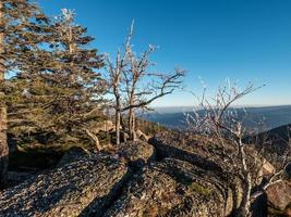 White snow and blue sky. Panoramic view of the silhouettes of the mountains. photo