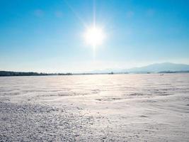 Snow-covered white fields in Alsace, top view. White desert. photo