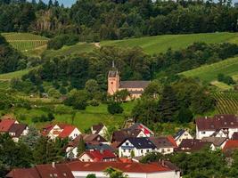 Little cozy german village between the green hills, vineyards in Black Forest photo