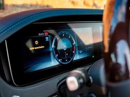 Luxury car dashboard with sunset reflections in the glass photo