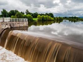 Powerful waterfall on the Kinzig river. Full-flowing river after the rains. photo