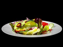 Fresh vegetable salad, cucumbers, radishes, lettuce, tomatoes. photo