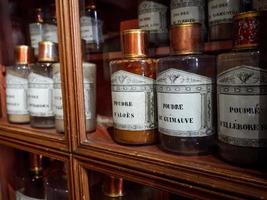 Vintage vials with ointments, infusions and powders, homeopathy. Medieval pharmacy. photo