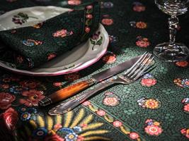 A simple but elegant tablecloth and cutlery laid out on it. Crystal glasses in the sun. Everything is ready for lunch in the garden. photo