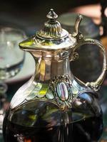 Wine jug made of crystal and silver. Antique item for the table. Elegant rich dishes for decorating a feast. photo