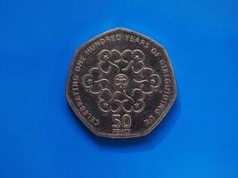 50 pence coin, United Kingdom over blue photo