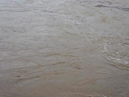 Brown muddy water surface background photo