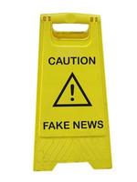 Fake news danger sign isolated over white photo