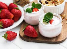 healthy breakfast, yogurt, fresh strawberries and granola photo