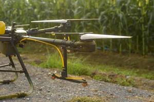 Agriculture drone flying and spraying fertilizer and pesticide over farmland,High technology innovations and smart farming photo