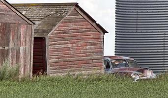 Wooden Granary and old car photo