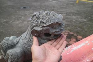 a stone statue of a little lion photo