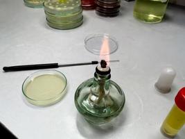 Close-up of an ethanol burner, also known as a spirit lamp, in a microbiological laboratory. Science concept. photo