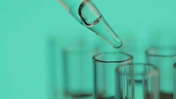 Close up of laboratory scientist working with a pipette analyzes and extract the DNA or molecules in the test tubes.on blur background with virtual interface video