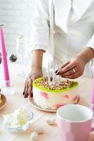 Woman in white party clothes preparing birthday table photo