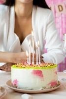 Woman in white party clothes preparing birthday table photo
