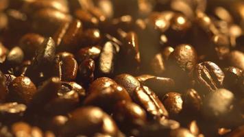 Macro shot of cup with hot coffee on roasted coffee beans in 4K video