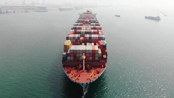 Aerial top view of cargo ship carrying container and running for export  goods  from  cargo yard port to custom ocean concept technology transportation , customs clearance.
