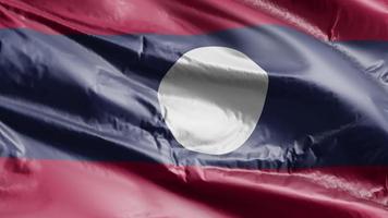 Laos flag waving on the wind loop. Laotian banner swaying on the breeze. Full filling background. 10 seconds loop. video