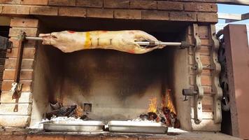 Spit Roasted Lambs, traditional way of roasting lambs on a rotisserie spit in Bulgaria. Cheverme.. photo