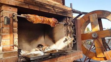 Spit Roasted Lambs, traditional way of roasting lambs on a rotisserie spit in Bulgaria. Cheverme.. photo