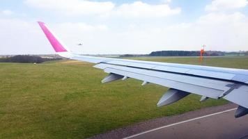 Wizzair plane approaches the runway while another plane lands. photo