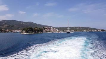 Water trail foaming behind a ferry on the way to a greece island. photo